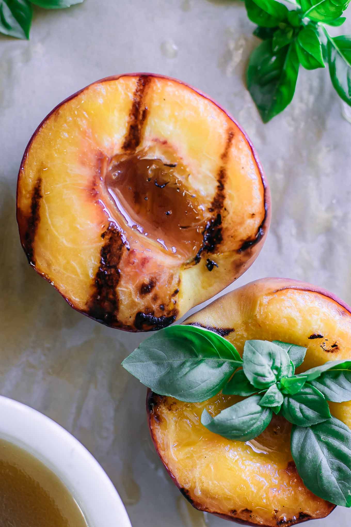 grilled peaches on a wood table