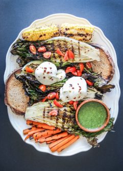 Grilled Romaine Burrata Salad, a platter of grilled heads of romaine topped with creamy burrata cheese, grilled summer vegetables and a garlic dill dressing drizzle. A perfect starter for summer barbecues!