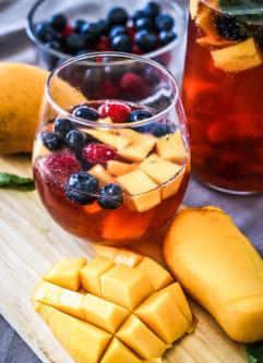 Take advantage of rosé season with this Mango Berry Rosé Sangria. Sparkling pink rosé, mangos, berries and brandy - perfect for your next summer soirée!