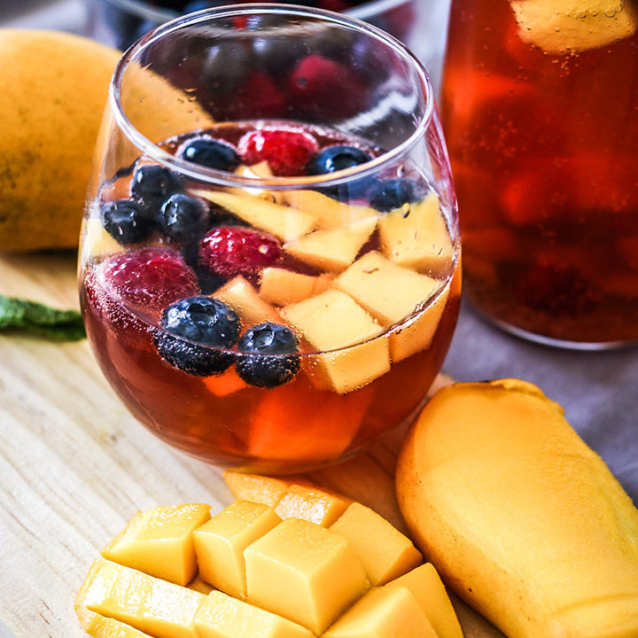 Take advantage of rosé season with this Mango Berry Rosé Sangria. Sparkling pink rosé, mangos, berries and brandy - perfect for your next summer soirée!