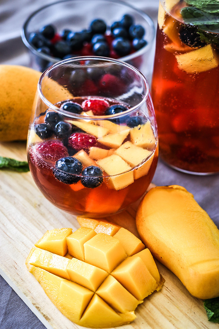 Take advantage of rosé season with this Mango Berry Rosé Sangria. Sparkling pink rosé, mangos, berries and brandy - perfect for your next summer soirée!