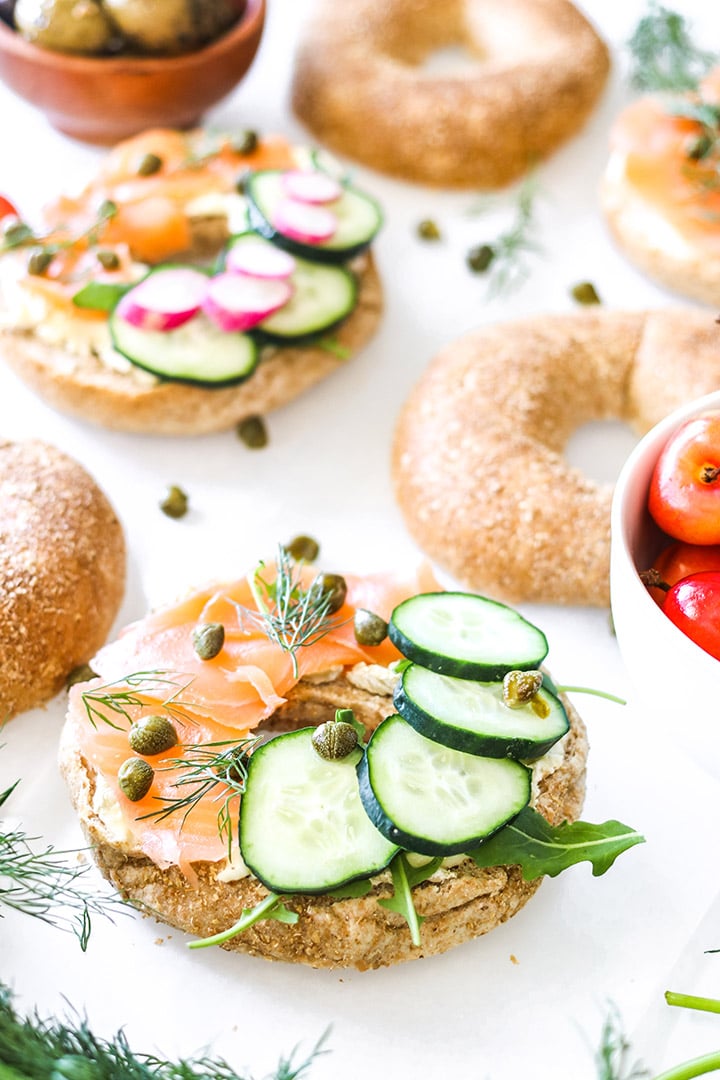 Smoked salmon bagels with cream cheese, dill, capers and all the veggies! Easy recipe for brunch or a weeknight no-cook dinner.