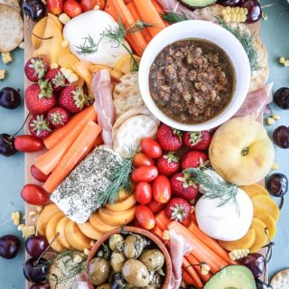An easy summer crudite platter with sliced veggies, seasonal fruit, creamy cheeses and fresh herbs. Basically summer on a plate!