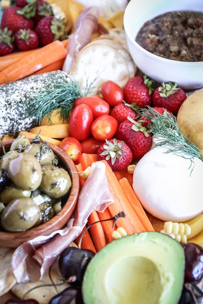 An easy summer crudite platter with sliced veggies, seasonal fruit, creamy cheeses and fresh herbs. Basically summer on a plate!