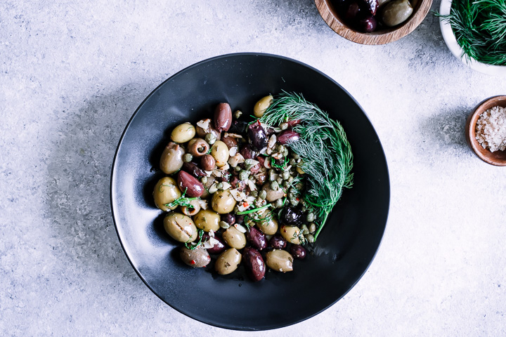 A mixture of green and kalamata olives with capers and herbs.