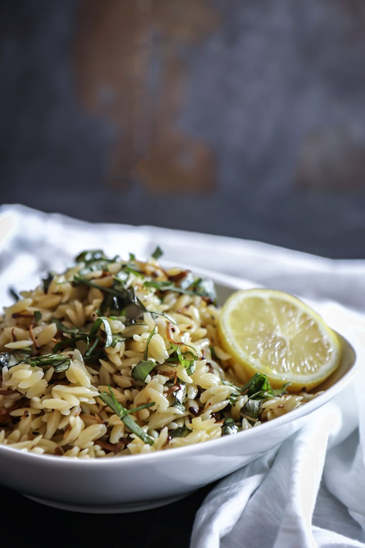 Vegan Mushroom Orzo Salad with enoki, fresh basil and drizzled in black truffle oil. Served warm or cold this vegan pasta salad is comfort food at its best!