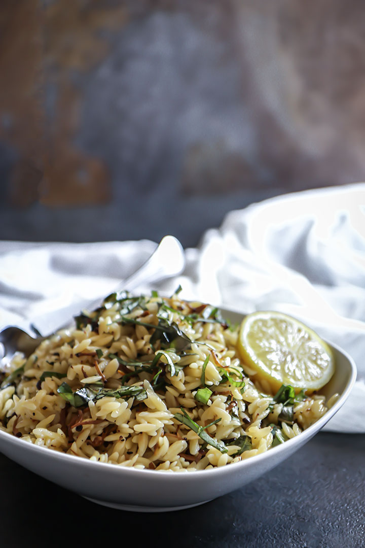 Vegan Mushroom Orzo Salad with enoki, fresh basil and drizzled in black truffle oil. Served warm or cold this vegan pasta salad is comfort food at its best!