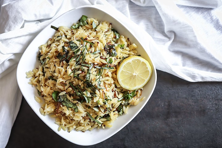 Vegan Mushroom Orzo Salad with enoki, fresh basil and drizzled in black truffle oil. Served warm or cold this vegan pasta salad is comfort food at its best!