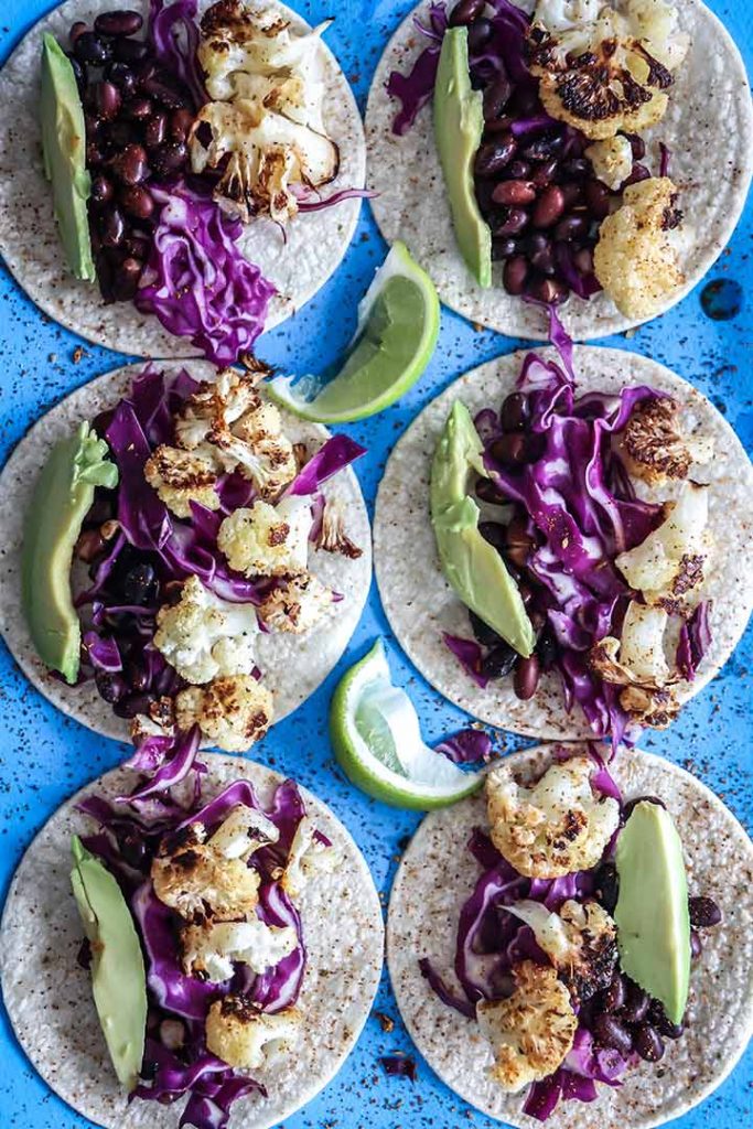 Chili lime Cauliflower Tacos made with roasted cauliflower, chili powder, fresh lime, black beans and avocado. A vegan take on Taco Tuesday!