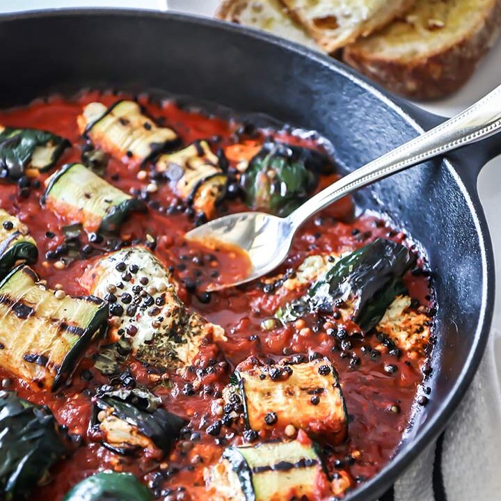 Grilled Zucchini Goat Cheese Bake - zucchini stuffed with herbed goat cheese and baked with marinara sauce. Serve with fresh bread for an easy dinner!