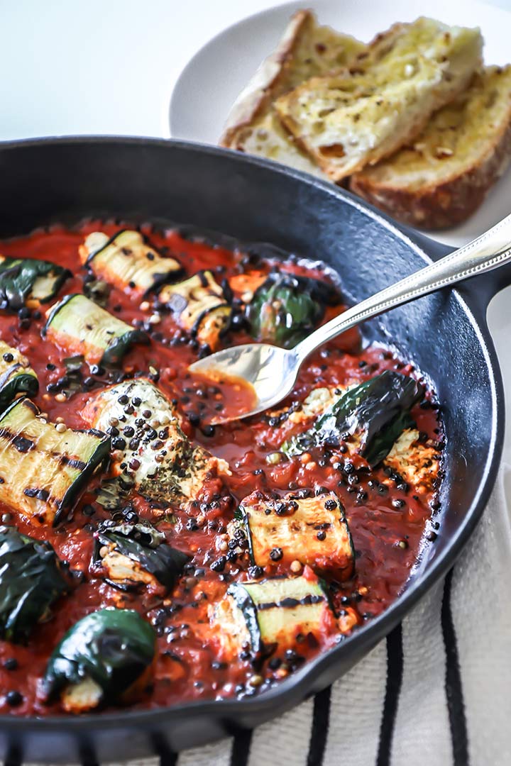 Grilled Zucchini Goat Cheese Bake - zucchini stuffed with herbed goat cheese and baked with marinara sauce. Serve with fresh bread for an easy dinner!