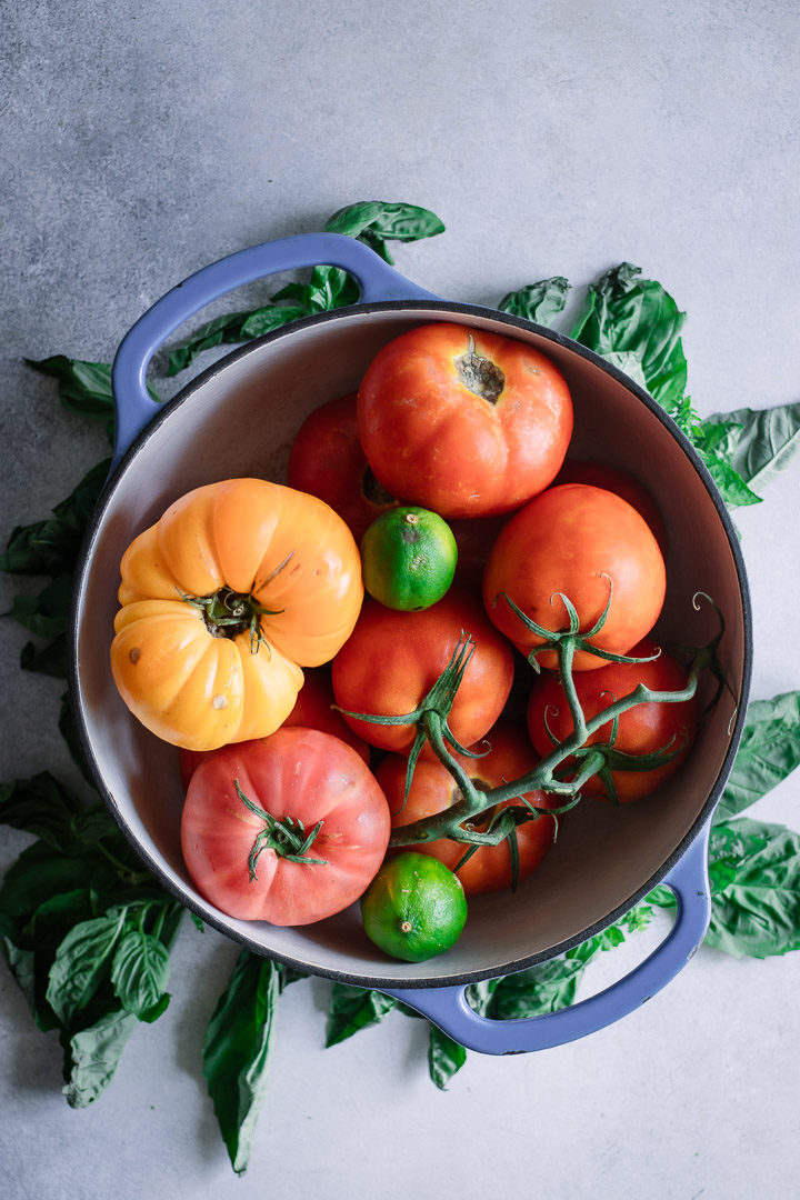 A soup pot filled with yellow and red tomatoes.