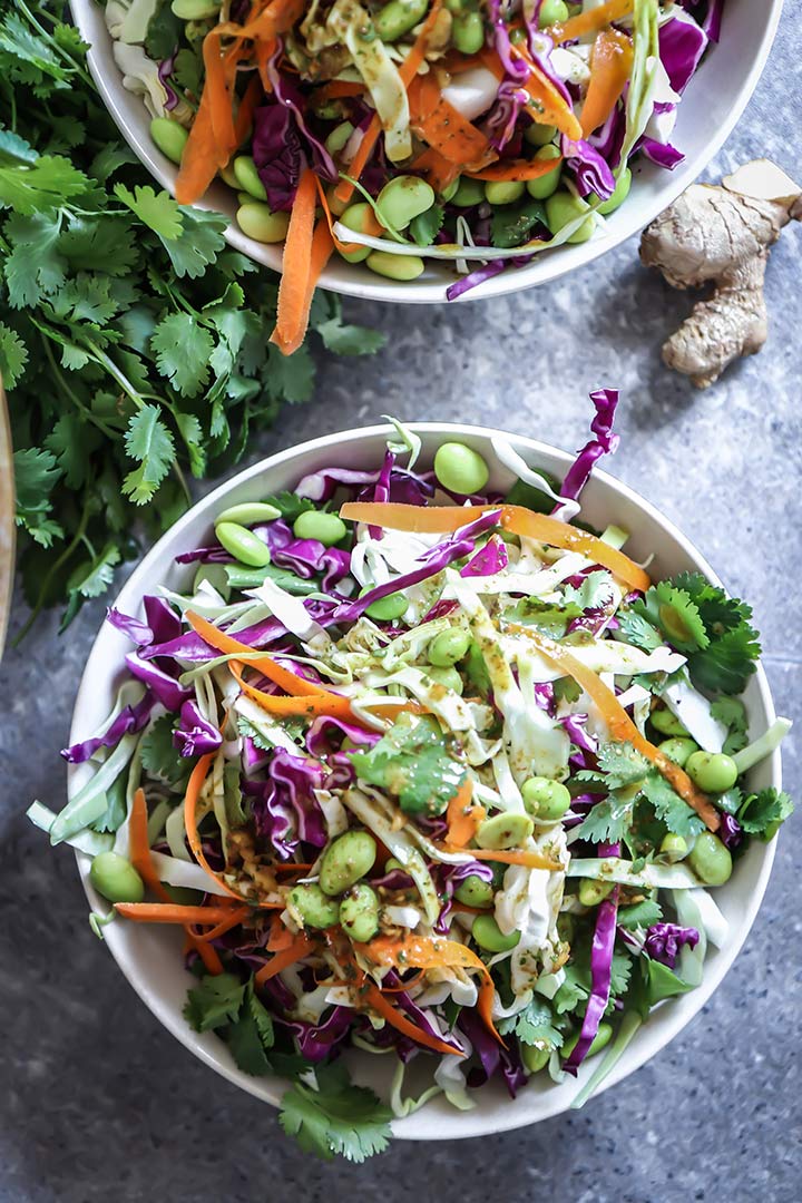 Miso Ginger Edamame Slaw, a light and fresh take on traditional coleslaw featuring green and red cabbage, edamame and a miso ginger dressing.