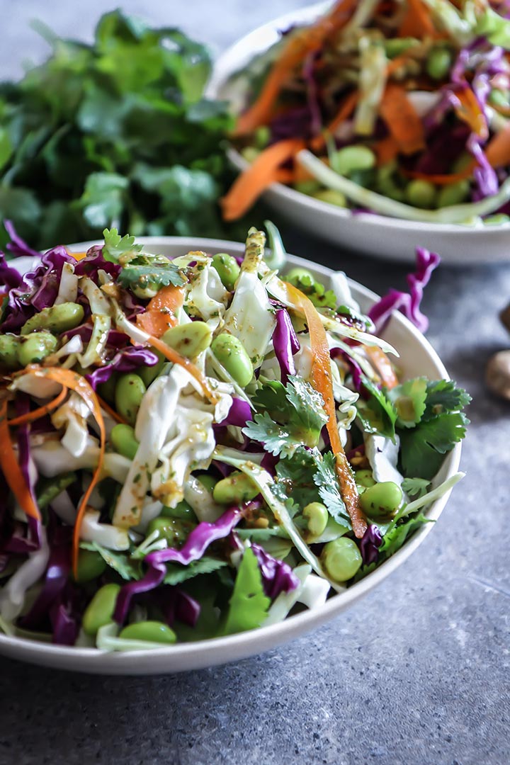 Miso Ginger Edamame Slaw, a light and fresh take on traditional coleslaw featuring green and red cabbage, edamame and a miso ginger dressing.