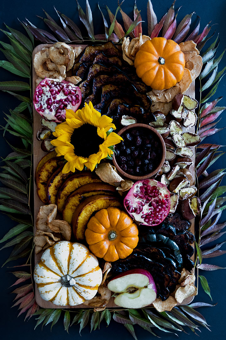 Fall Harvest Snack Board, a pickable platter of roasted pumpkin, acorn squash and autumn chestnuts with dried apple chips, pomegranate and cranberries.
