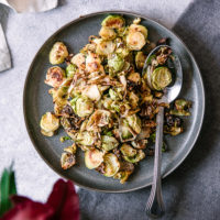 A simple brussels sprouts side dish on a white table for Thanksgiving