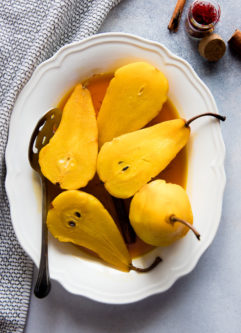Saffron Poached Pears, a simple and seasonal fall and winter baked fruit dessert with saffron, apple cider vinegar, cinnamon, and brown sugar.