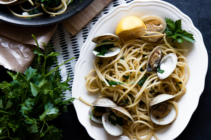 a plate of pasta with clams (pasta con vongole) with fresh parsley