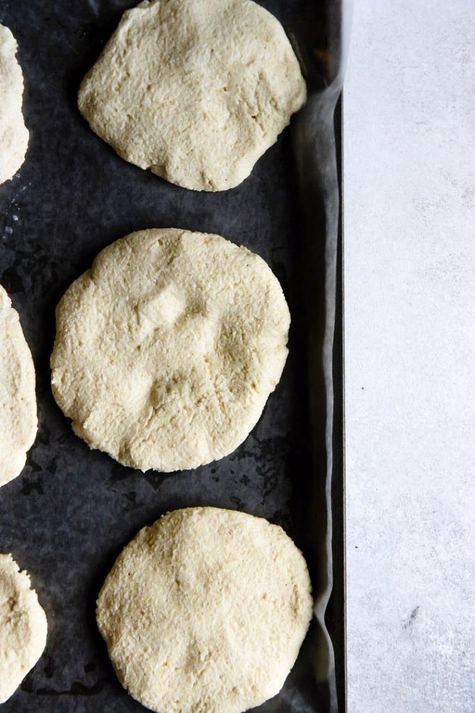 Colombian spicy vegetable arepas recipe dough before cooking on a dark pan.