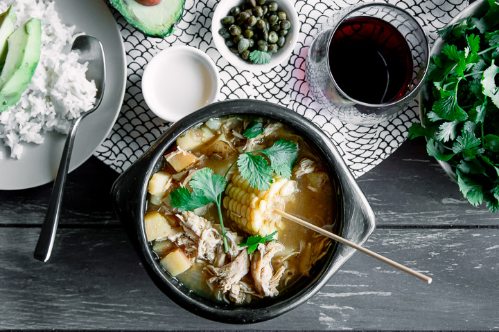 Wow, this was delicious! Colombian Ajiaco, a traditional chicken and potato soup from Bogota. Made with three types of potatoes, corn, cilantro, green, onion, capers, cream, avocado, and the South American guascas herb, this Colombian soup will make you feel like you’re eating in Bogota! #colombia #colombianfood #soup #stew #bogotano