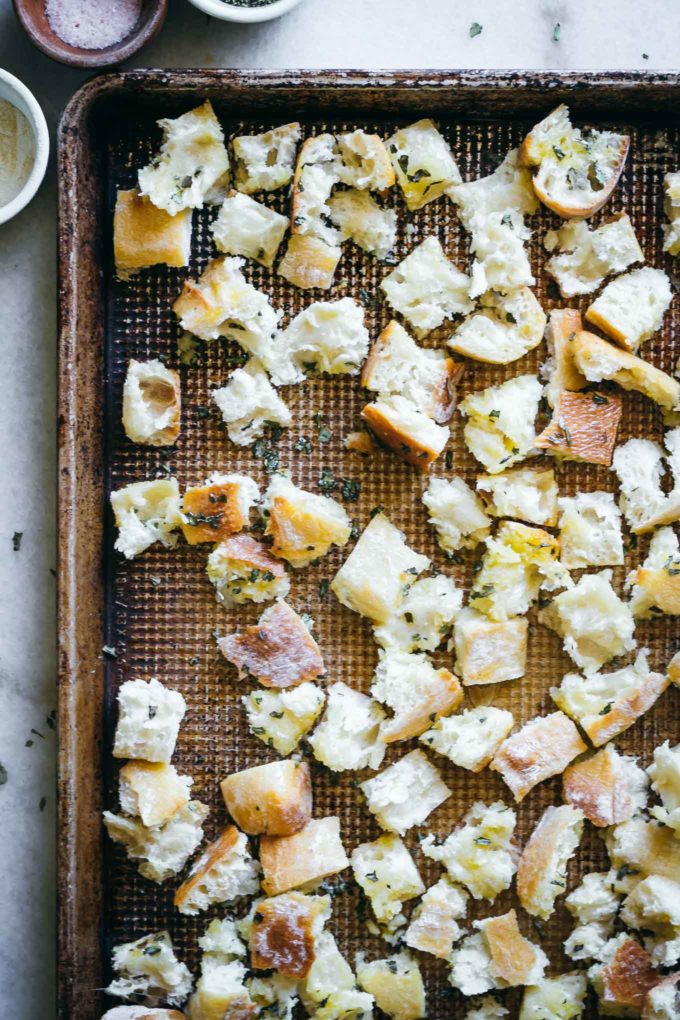 baked croutons on a baking sheet on a white table