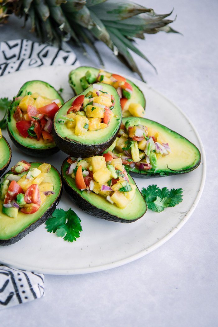 Avocados cut in half and stuffed with pico de gallo.