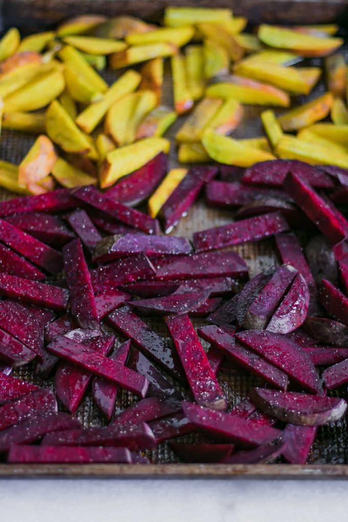 sliced red and golden beets on a sheet pan