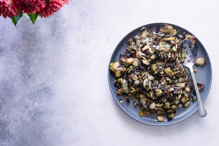 A plate of baked roasted brussels sprouts with kimchi.