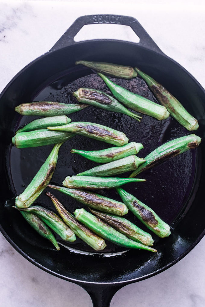 A cast iron skillet with okra.