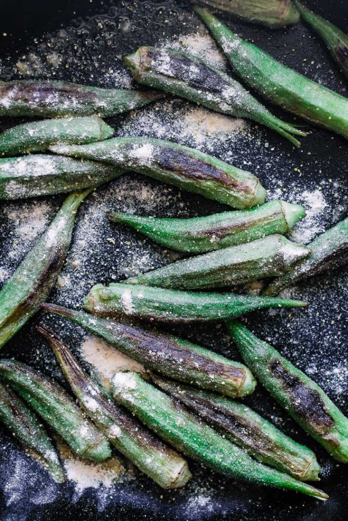 Okra with cormeal breading in a cast iron skillet.