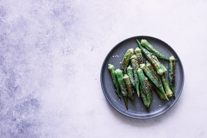 Okra on a plate on a white and blue table.