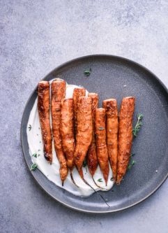 Carrots on a blue plate on a blue table.
