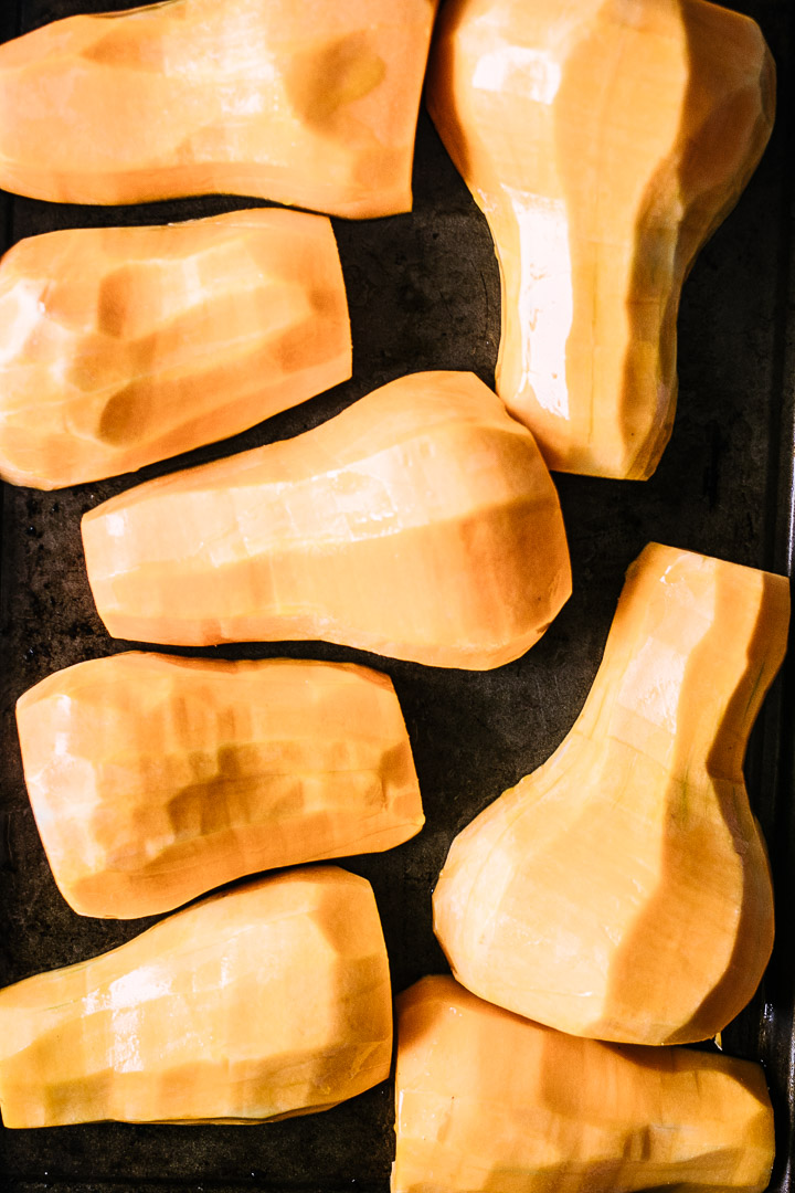 peeled butternut squash on a baking sheet