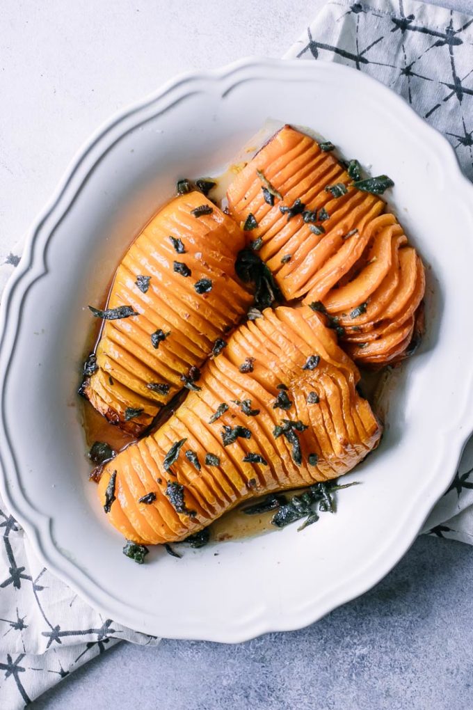 Hasselback cut butternut squash on a white plate