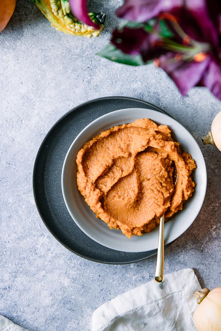 A bowl of pumpkin puree on a white table