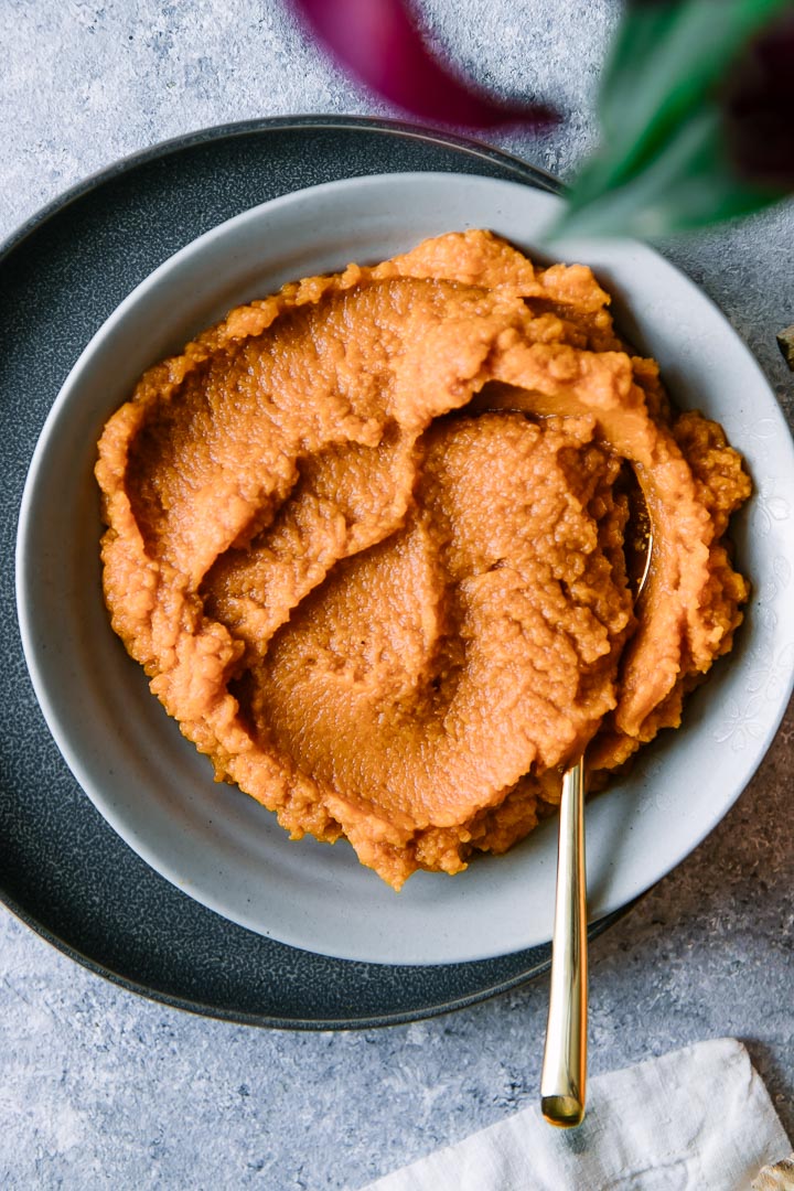 orange pumpkin puree in a bowl on a Thanksgiving table