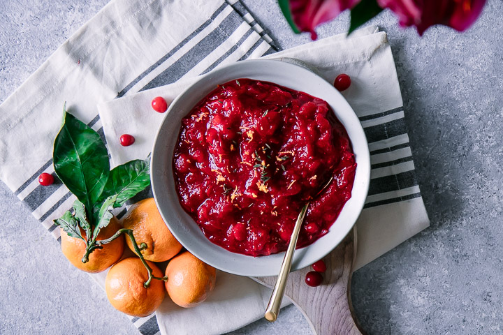 A bowl of cranberry sauce with orange zest and thyme