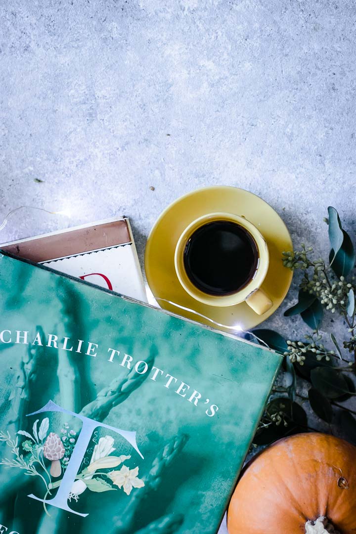 Coffee and cookbooks on a white winter table