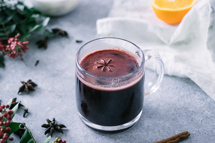 a hot mug of gluwhein on a christmas holiday table