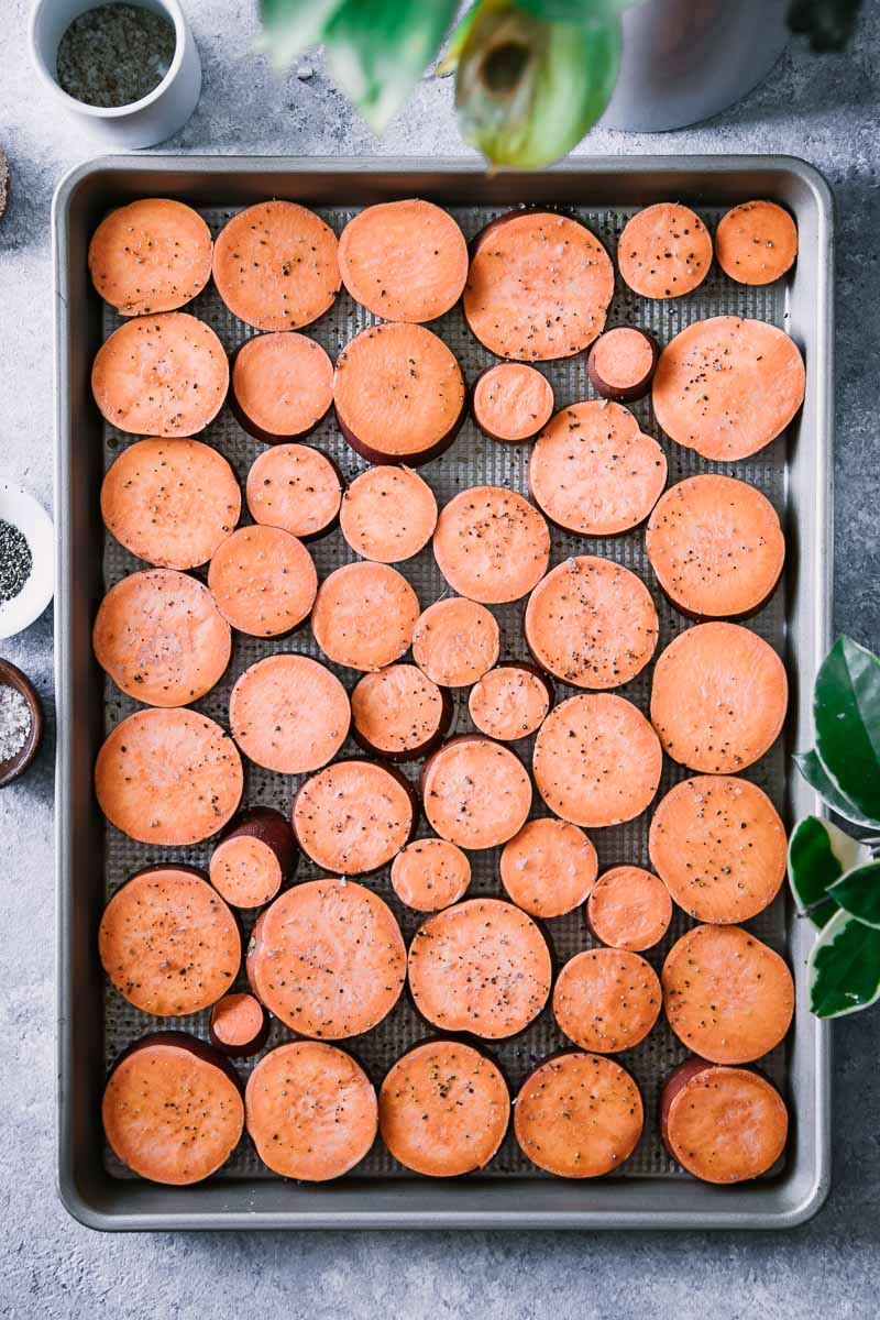 sliced sweet potatoes on a baking sheet
