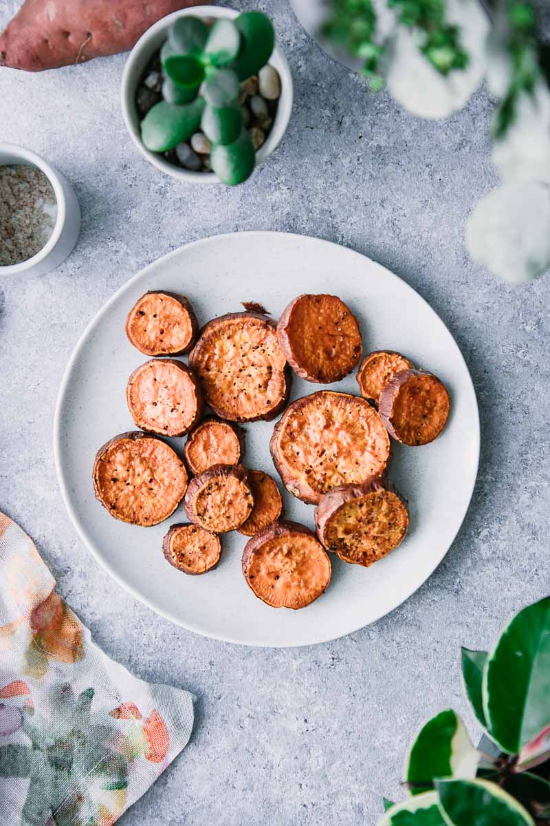 baked and sliced yams on a white plate