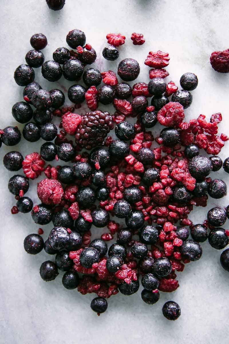 frozen blackberries, blueberries, and raspberries on a white table