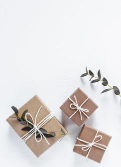 Gifts in natural gift wrap on a white table