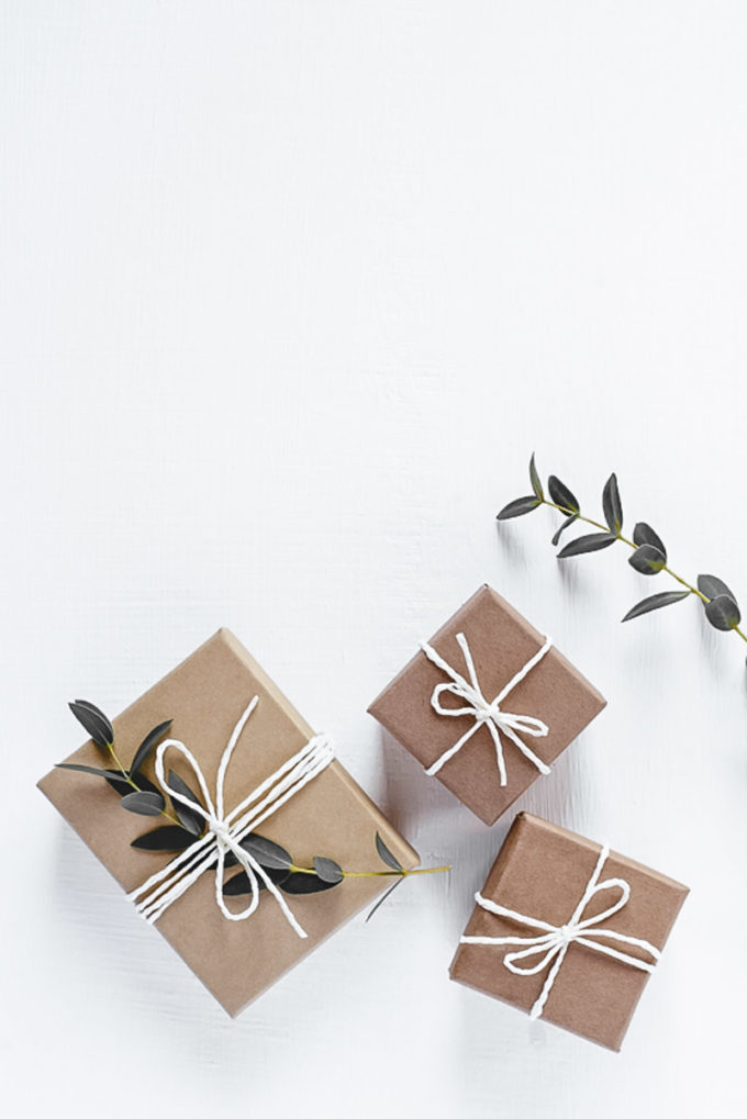 Gifts in natural gift wrap on a white table