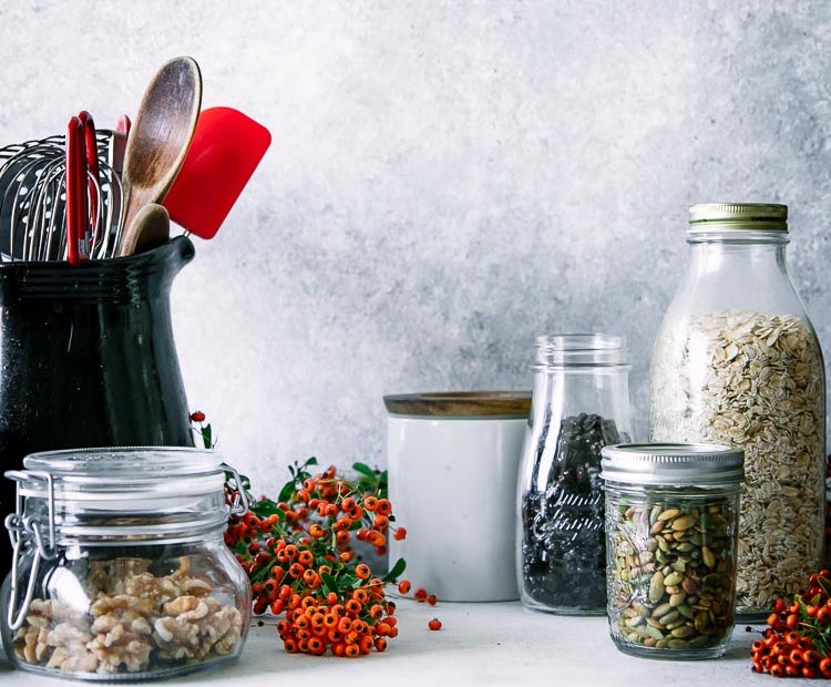 eco-friendly food storage jars on a white table to reduce food waste