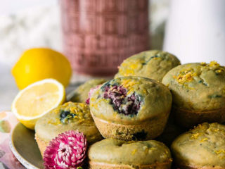 berry muffins on a plate with the words "lemon berry cornbread muffins" in black writing