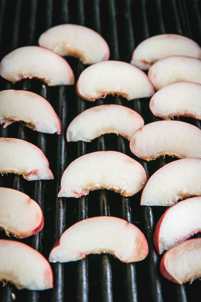 sliced peaches on a grill