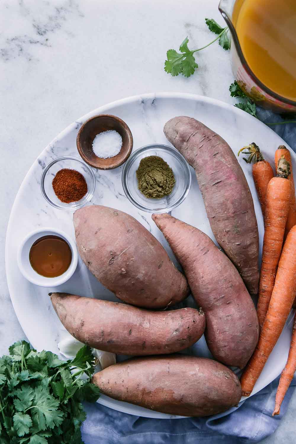 sweet potatoes, carrots, vegetable broth, spices, and herbs to make a simple instant pot sweet potato carrot soup