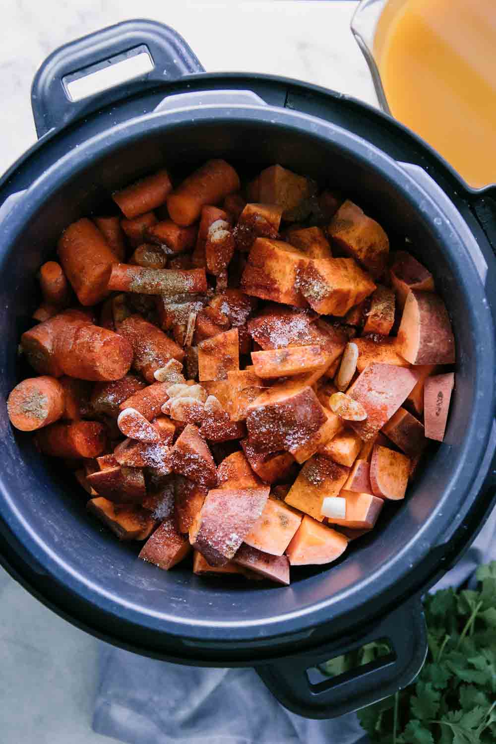 chopped sweet potatoes, carrots, and spices in an Instant Pot or pressure cooker