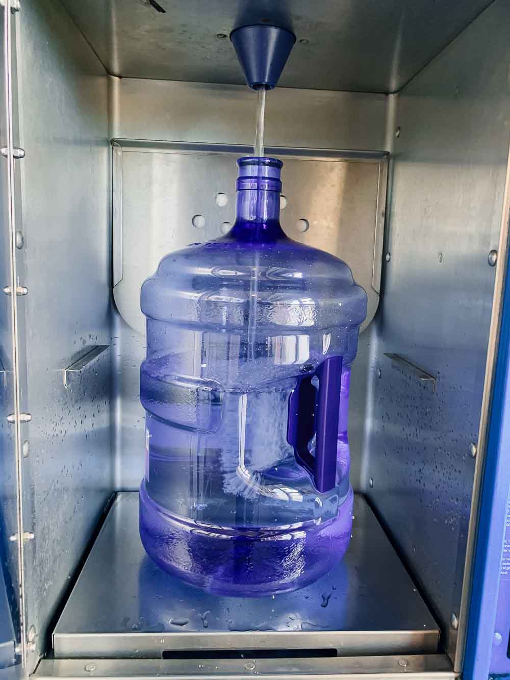 a refillable 5-gallon water bottle at a primo glacier water refill station